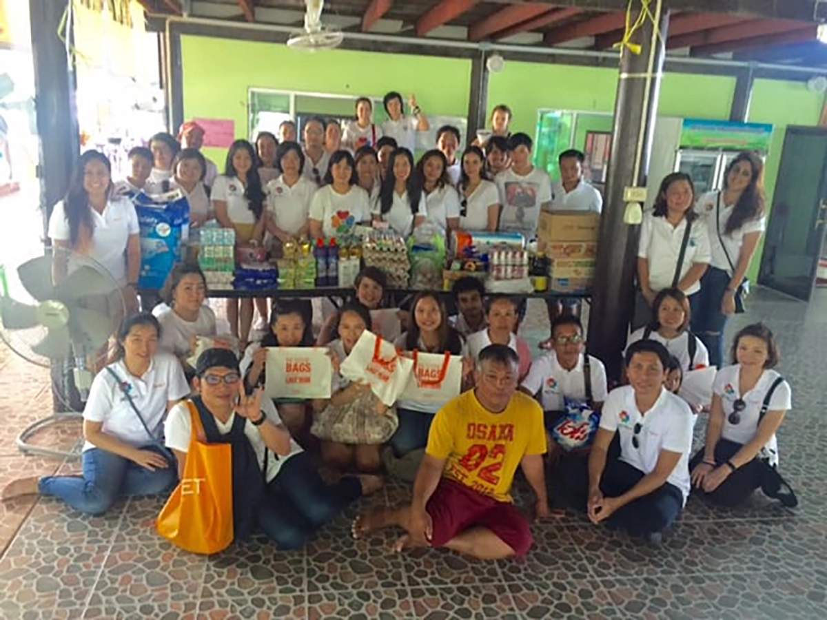 Qnet Spends Quality Time With Abandoned Elders In Thailand 4 QNET staff outside at charity event