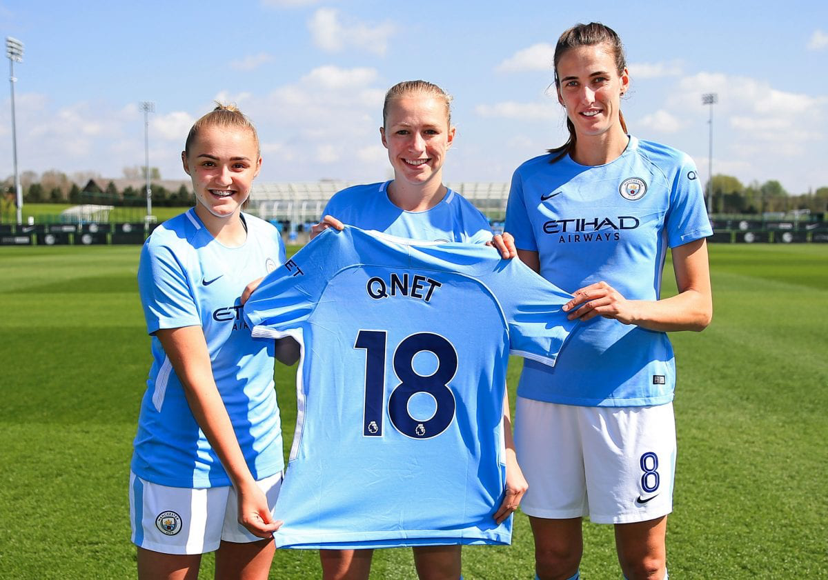 3 women footbal players holding QNET jersey
