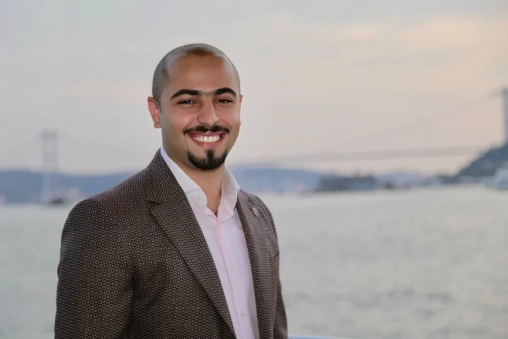 Global Entrepreneurship Month: Qnet Success Stories To Inspire 11 Mustafa Negm in an ocean background