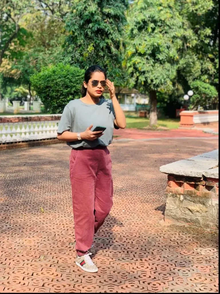 Asma Abid walking outside on tiles
