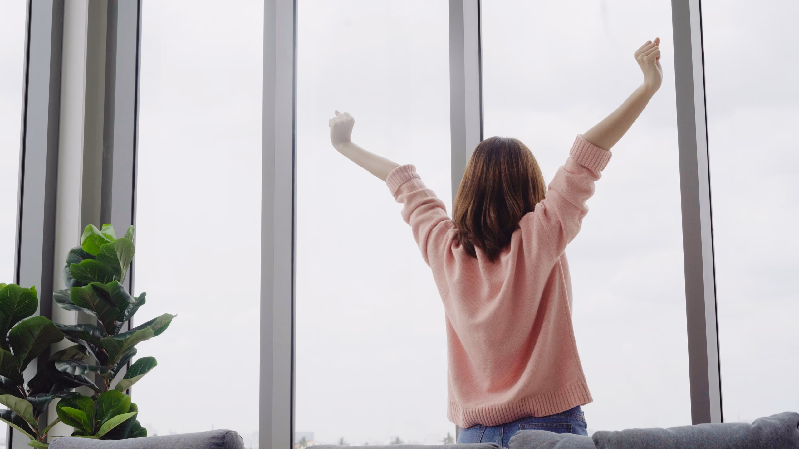 Everything You Need To Know About Exercise And Air Quality 2 A girl stretching her body after she wake up at home with fresh air.