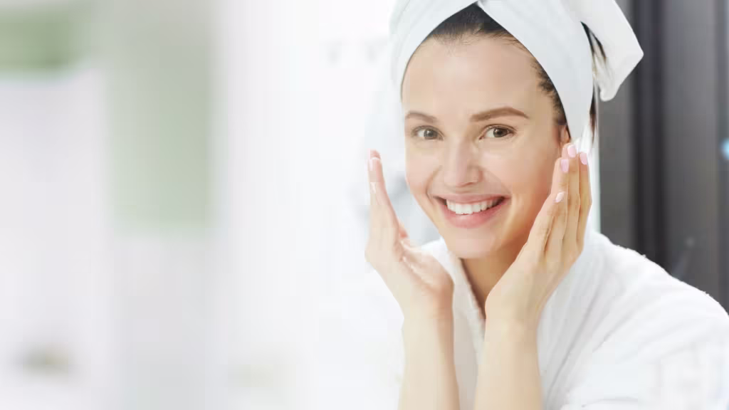 Winter Skincare Tips And Products To Help You Glow In The Cold 2 Woman in white robe applying skincare routine from physio radiance