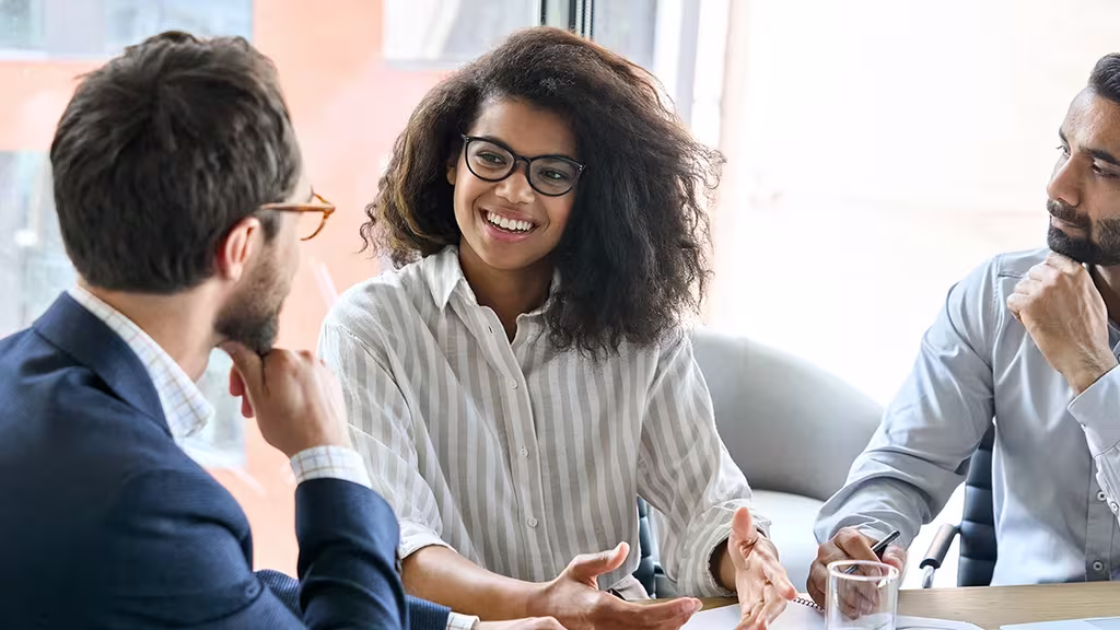 How Learning Helps Entrepreneurs Become Better At Business 5 Woman in meeting room while two men listening to her