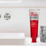 ProSpark toothpaste and wooden toothbrushes in a holder beside a bathroom sink