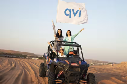 V-Convention Girls on a jeep with a QVI flag, riding in the desert where they enjoyed stress-free travel to for their holiday