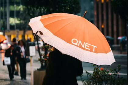 Rainy Season Tips by QNET - girl with an orange umbrella